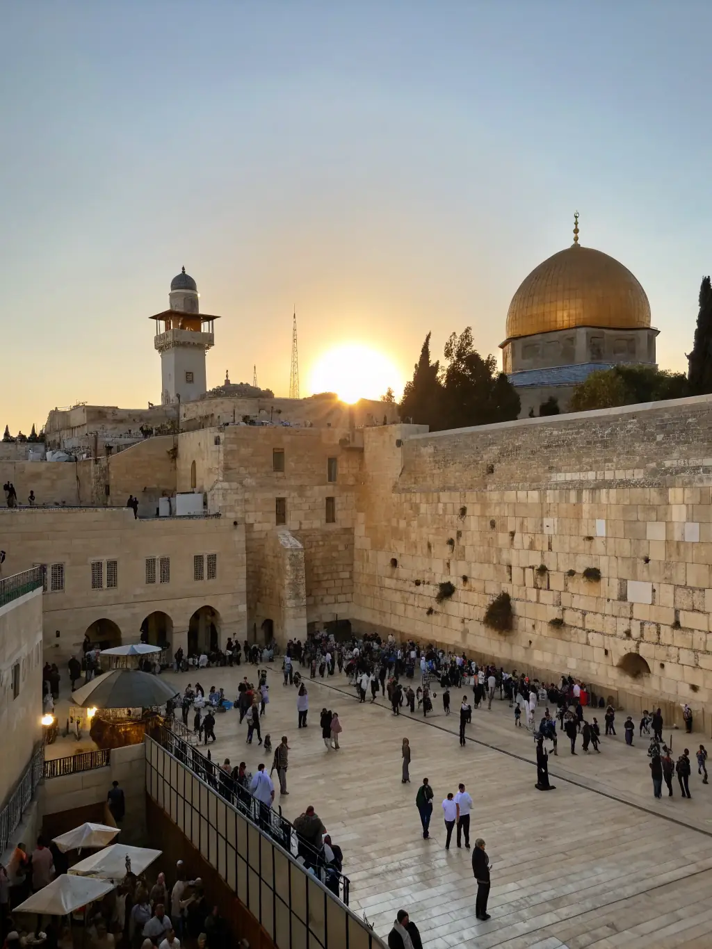 A professional photograph capturing the Western Wall in Jerusalem, with diverse visitors praying and reflecting, showcasing the spiritual significance of the site.